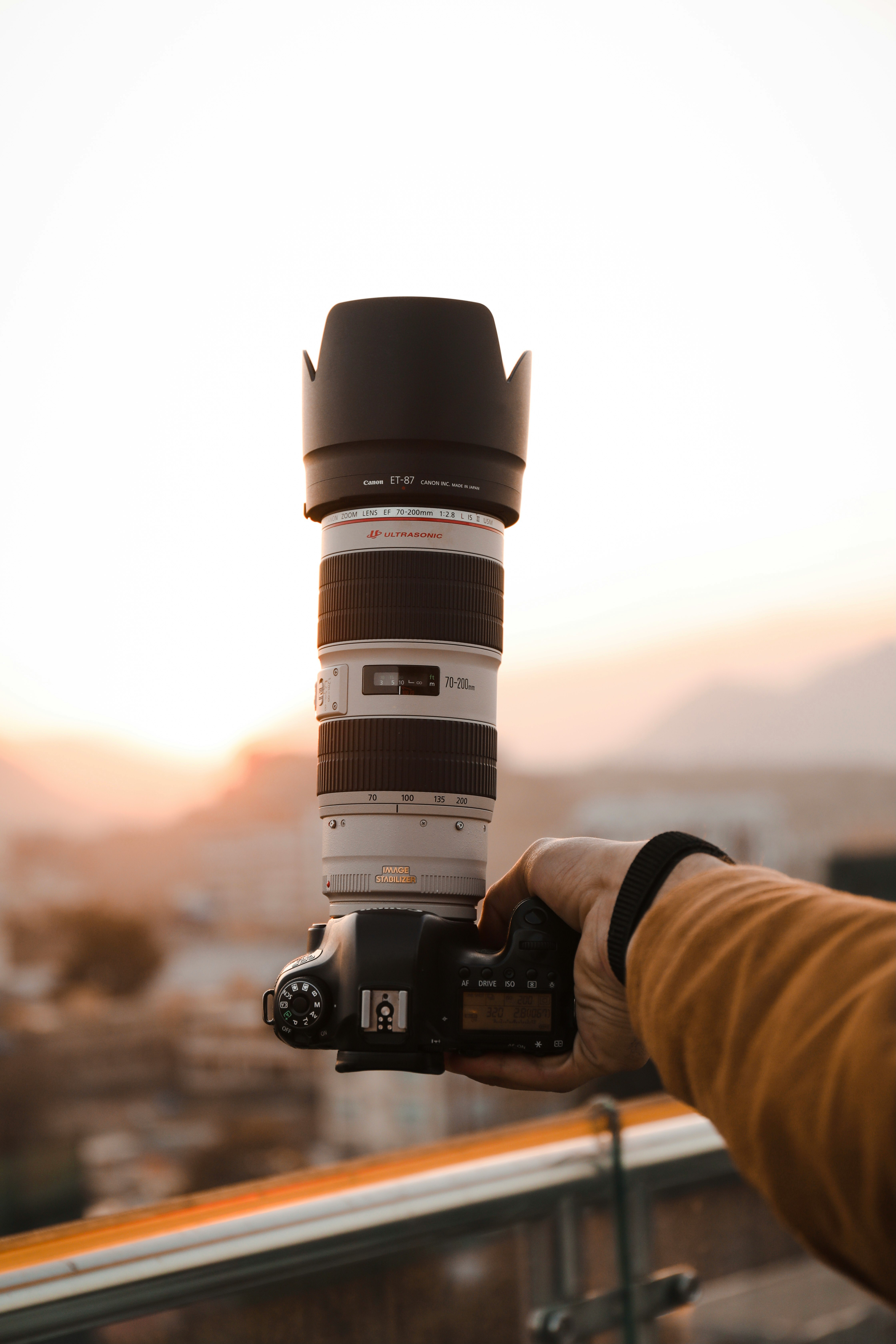 person holding black and white dslr camera